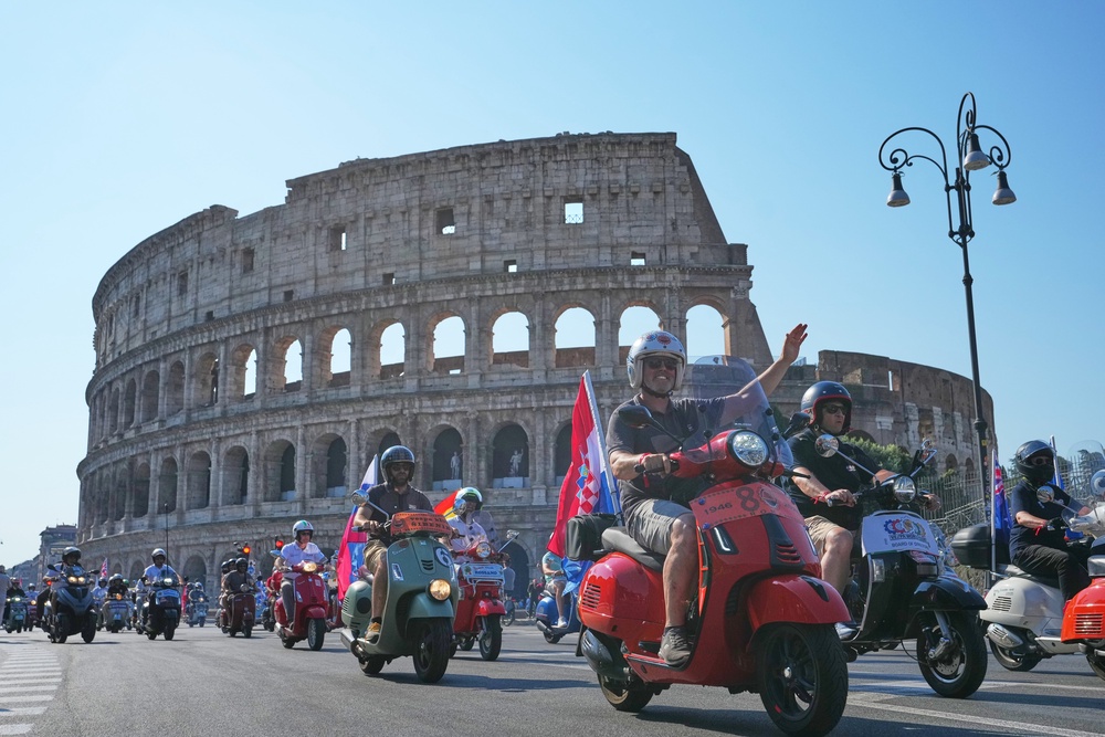 Vespa enthusiasts parade in front of the Colosseum during celebrations for the 80th anniversary of the Vespa scooter, in Rome, Saturday, June 27, 2026. (AP Photo/Alessandra Tarantino) (Copyright 2026 The Associated Press. All rights reserved)