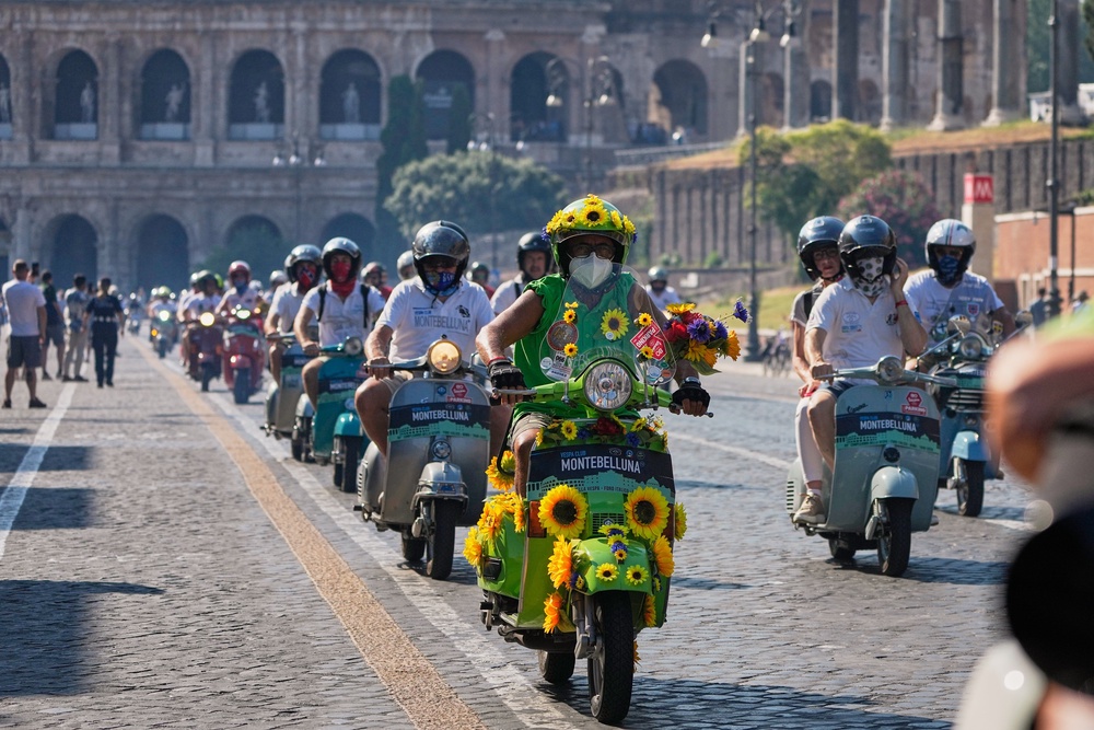 Vespa enthusiasts parade in front of the Colosseum during celebrations for the 80th anniversary of the Vespa scooter, in Rome, Saturday, June 27, 2026. (AP Photo/Alessandra Tarantino) (Copyright 2026 The Associated Press. All rights reserved)