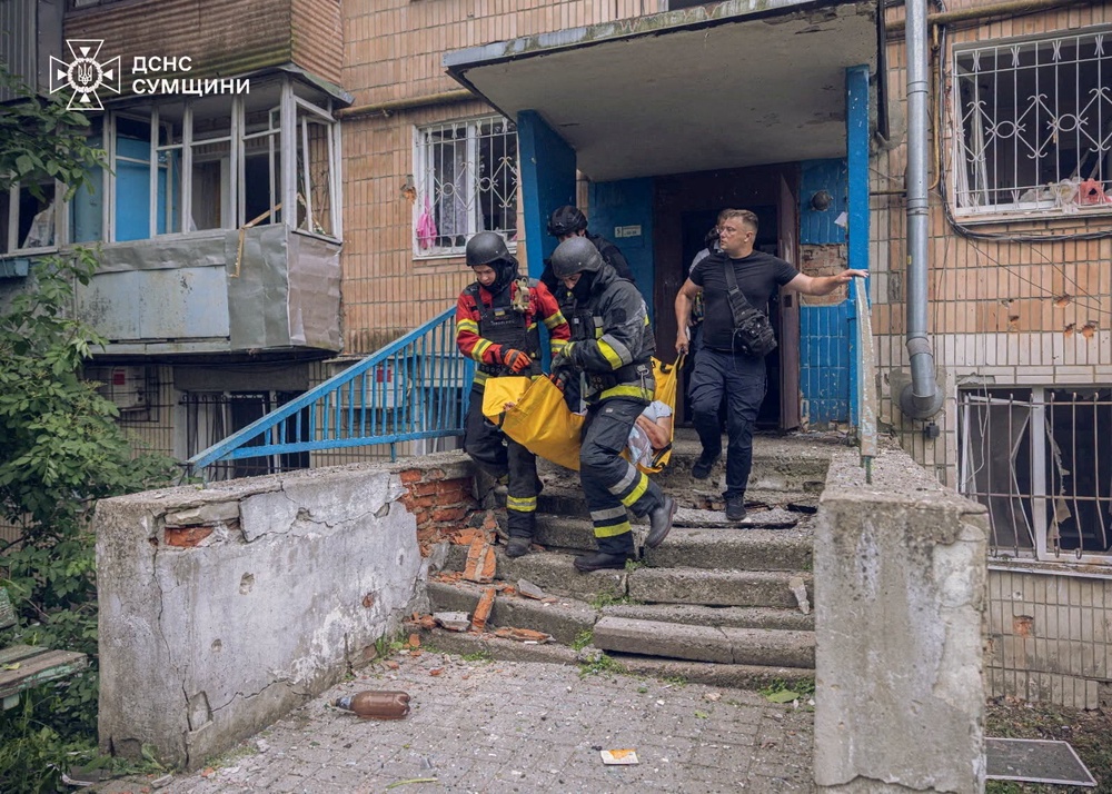 Rescuers respond to a Russian drone attack which struck an apartment building in Sumy, Ukraine, on Saturday (Reuters)