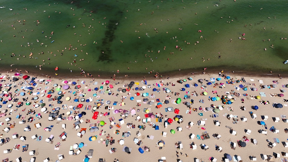 A drone view shows people at a beach as meteorologists forecast heat and record-breaking temperatures across the country in Timmendorfer Strand, Germany (Reuters)