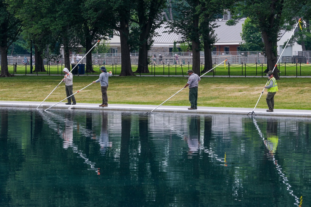 Workers clean algae from the Lincoln Memorial Reflecting Pool following the completion of recent renovations in Washington, D.C, June 26 (Reuters)