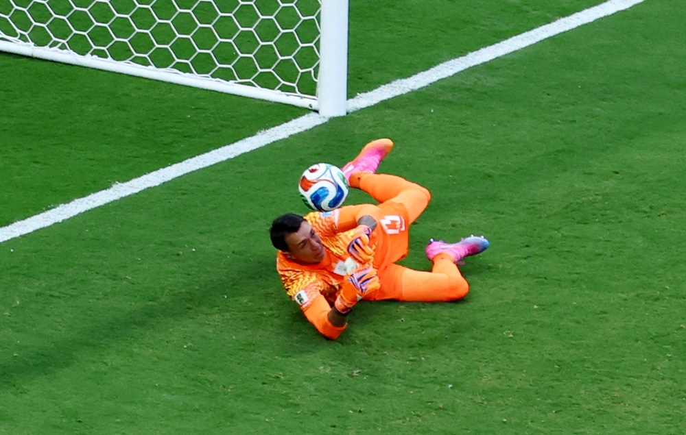 Spain's Alex Baena scores their first goal past Uruguay's Fernando Muslera (Reuters)