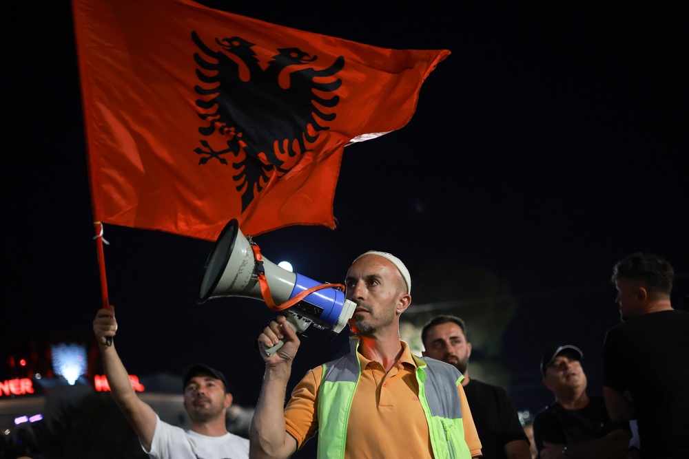 Arben Kola, a tour guide and one of the protesters against a coastal development project in western Albania linked to Donald Trump's son-in-law Jared Kushner, is photographed during a rally in Tirana, Albania, Saturday, June 27, 2026. (AP Photo/Hameraldi Agolli) (Copyright 2026 The Associated Press. All rights reserved)