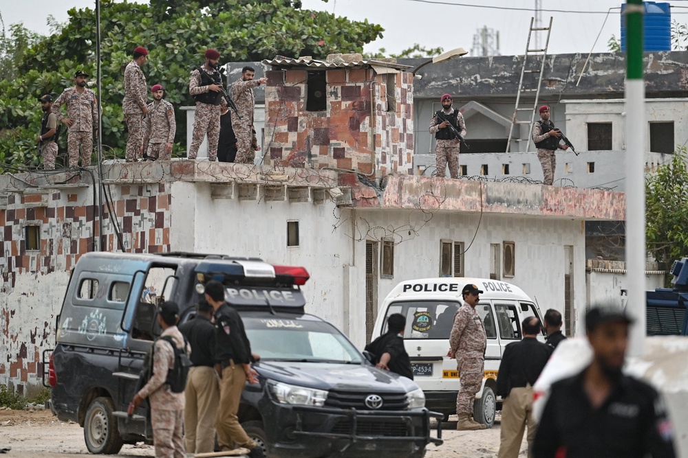 Security personnel inspect the rooftop of a compound at the end of a clearance operation following a militant attack in Karachi on 28 June 2026 (AFP/Getty)