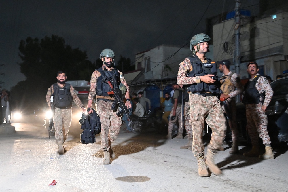 Soldiers conduct a clearance operation following a militant attack in Karachi on 28 June 2026 (AFP/Getty)
