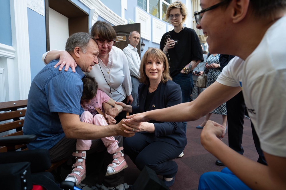 Rachel Reeves meets a family who are being supported by a social service delivery centre with UK backing (PA)