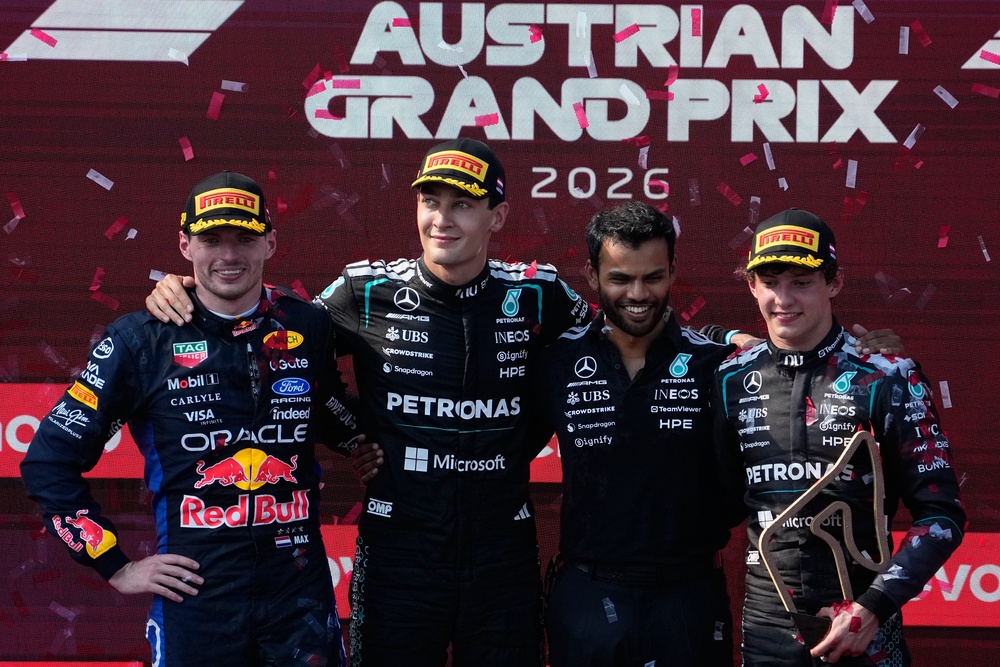 Russell (second left) on the podium with second-placed Max Verstappen (left) and third-placed Kimi Antonelli (right) (Darko Bandic/AP) (AP)