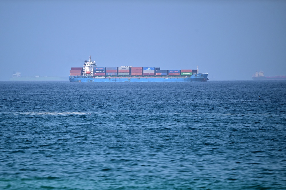 A cargo ship is pictured off coast of the Khor Fakkan Container Terminal, the only natural deep-sea port in the region and one of the major container ports in Sharjah Emirate, along the Gulf of Oman on 28 June 2026 (AFP/Getty)
