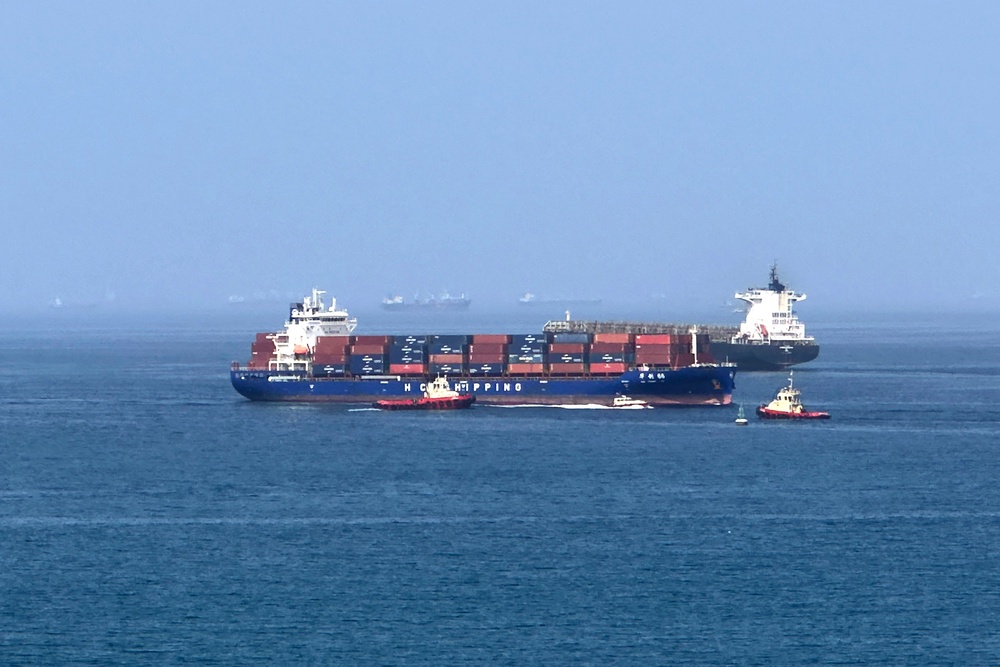 A cargo ship is pictured off coast of the Khor Fakkan Container Terminal, the only natural deep-sea port in the region and one of the major container ports in Sharjah Emirate, along the Gulf of Oman on 28 June 2026 (AFP/Getty)