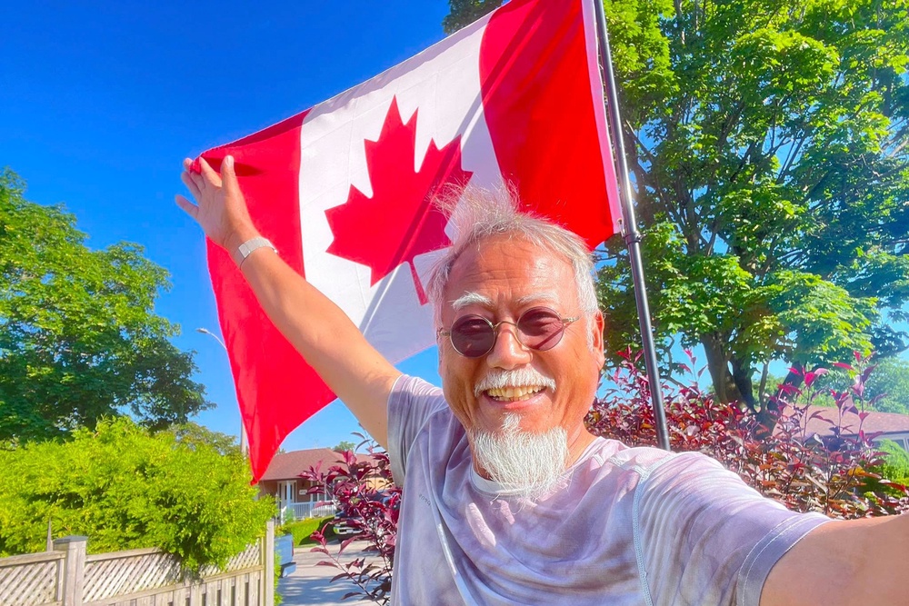 Dong Guangping poses for a photo with the Canadian flag after arriving in Toronto, Canada, on June 27, 2026 (Dong Guangping)