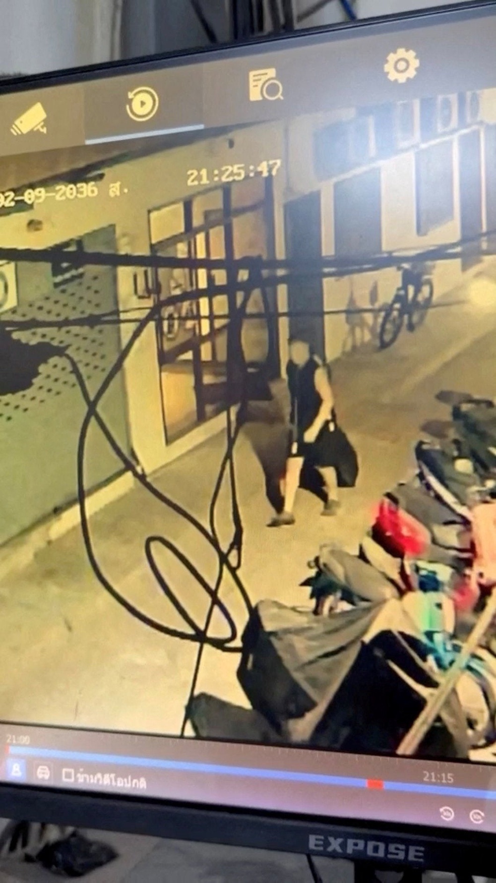 Simon Peter Carman walks with a suitcase outside a condominium, in Pattaya City, Thailand, in this screengrab obtained from a handout video released on 27 June 2026 (Pattaya Provincial Police Station)