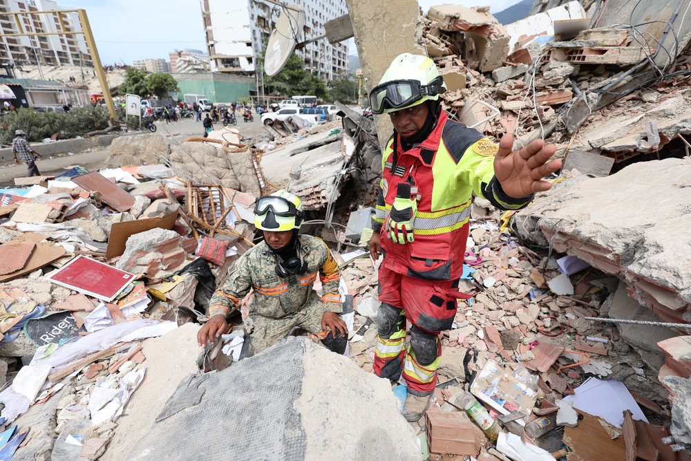 Rescuers work on the rubble of a collapsed building after a magnitude 7.2 earthquake that struck Venezuela and other regions in the Caribbean (Getty)