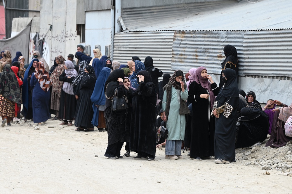 Afghans wait outside to seek news of their relatives at the site after Pakistani airstrikes hit the Omid Addiction Treatment Hospital in Kabul (AFP/Getty)