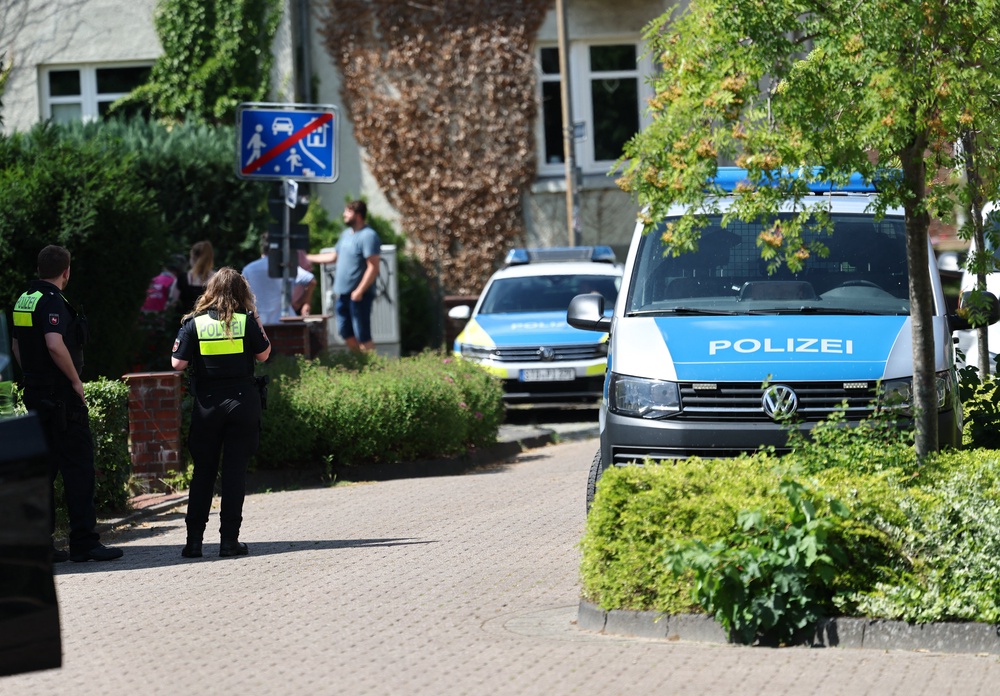 Police stand near the scene where five people were killed in a shooting in Stade (AFP/Getty)