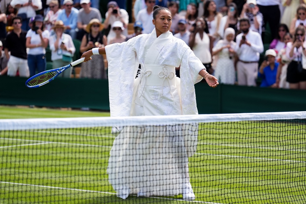 Naomi Osaka wore an all-white kimono on to court for her first-round win (PA Wire)