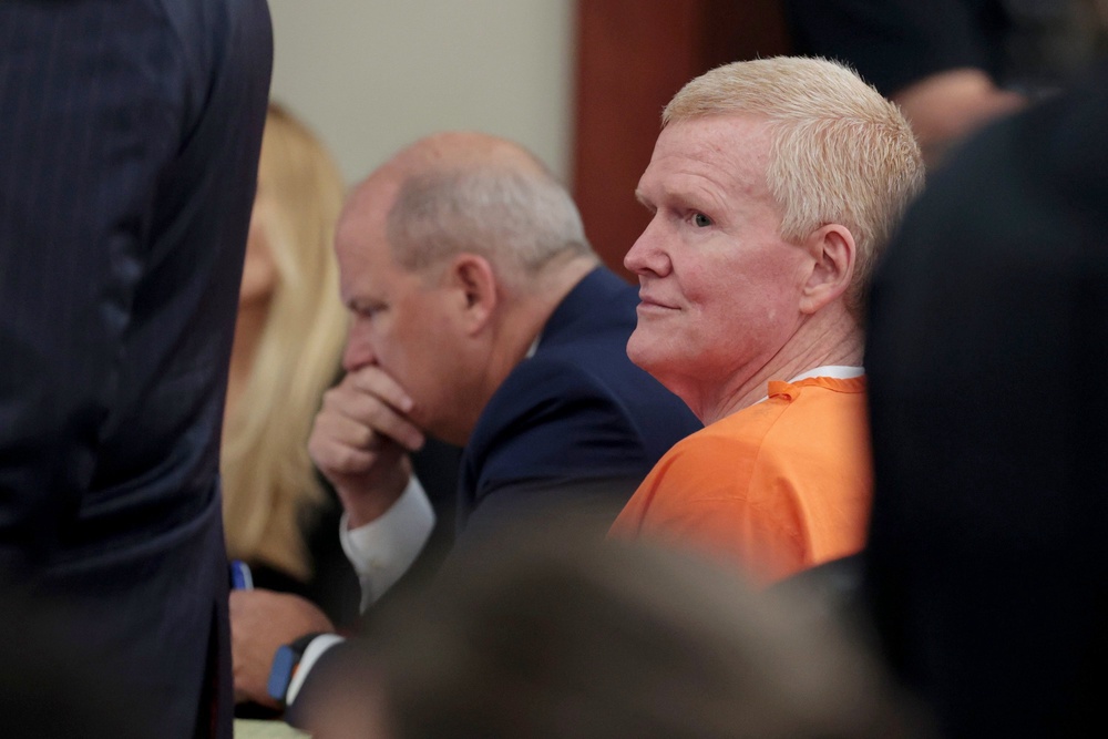 Murdaugh wore an orange prison jumpsuit in court Monday, mostly listening with his mouth fixed in a tight line (Tracy Glantz/Pool The State via)
