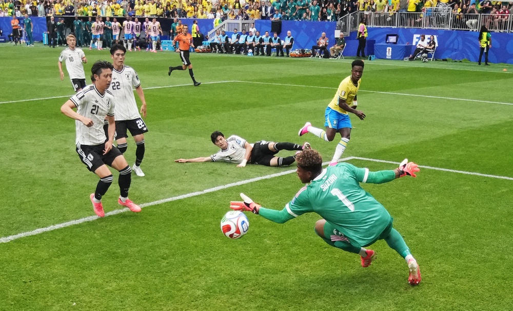 Japan's Zion Suzuki saves a shot from Brazil's Vinicius Junior (Reuters)