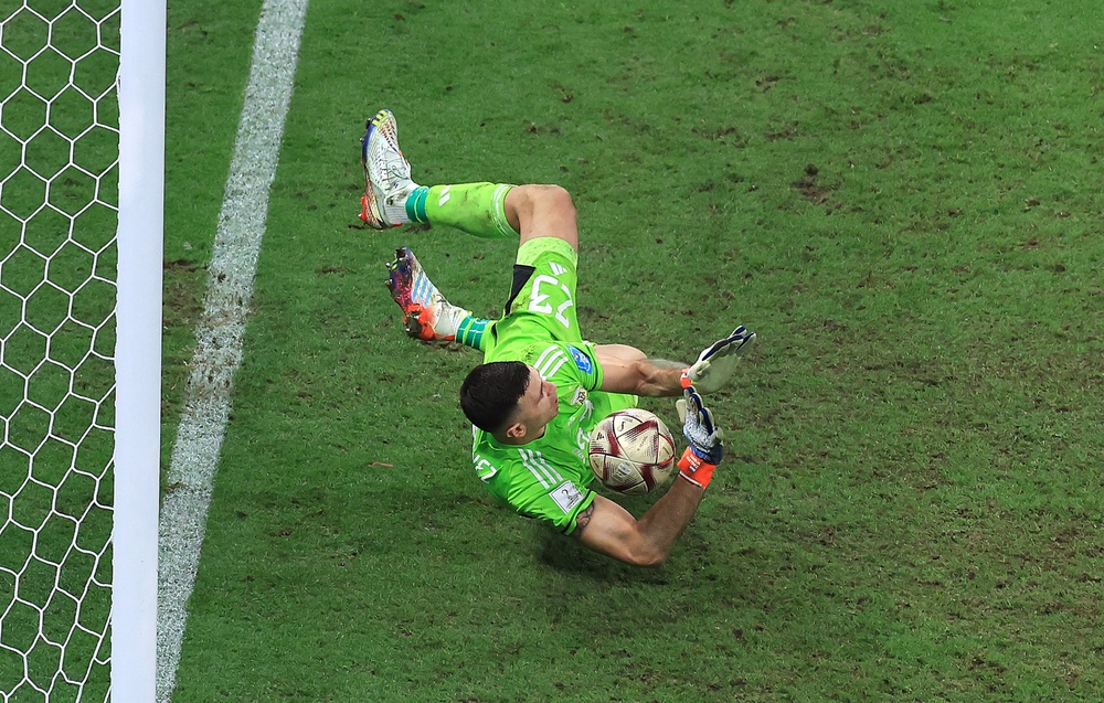 Emiliano Martinez saved Kingsley Coman's penalty in the 2022 World Cup final shootout (Getty)