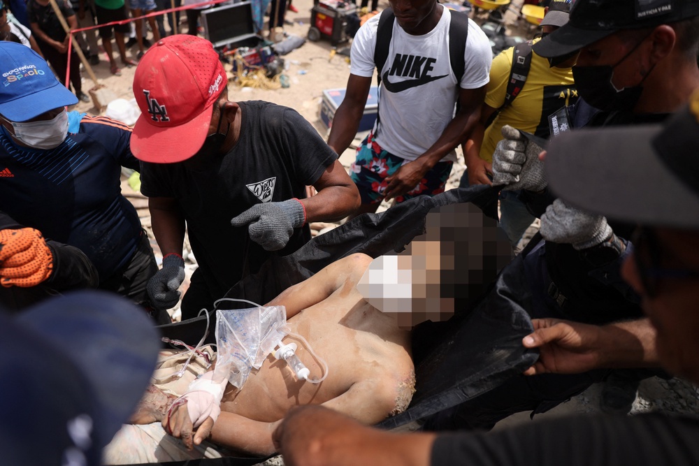 A person who was trapped under the rubble of a building is carried, after earthquakes hit the country, in La Guaira, Venezuela (Reuters)
