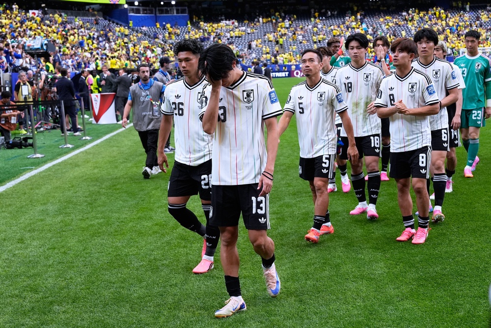 A disappointed Japan team leaves the field (AP)