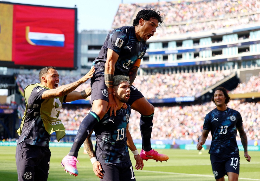Paraguay's Julio Enciso celebrates scoring their first goal with Gustavo Gomez (Reuters)