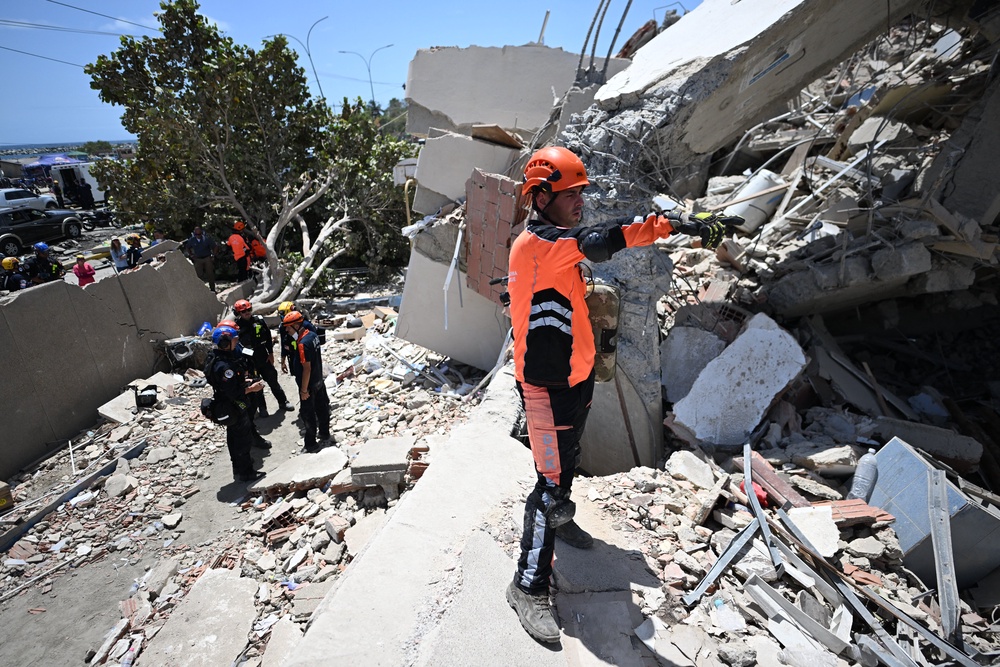 Turkish rescuers search through the rubble of a collapsed building in Caraballeda, La Guaira state, Venezuela (AFP/Getty)
