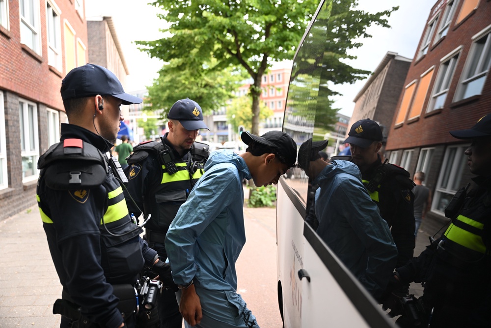 A fan is taken away by police (AP)