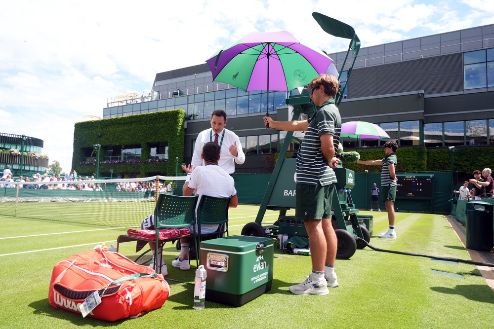 Damir Dzumhur speaking with match referee Jake Garner (PA)