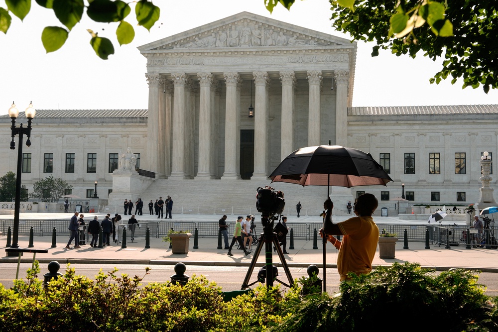 News reporters and spectators have begun to assemble outside the court ahead of a series of high-profile decisions expected to be handed down at 10 am. (Reuters)