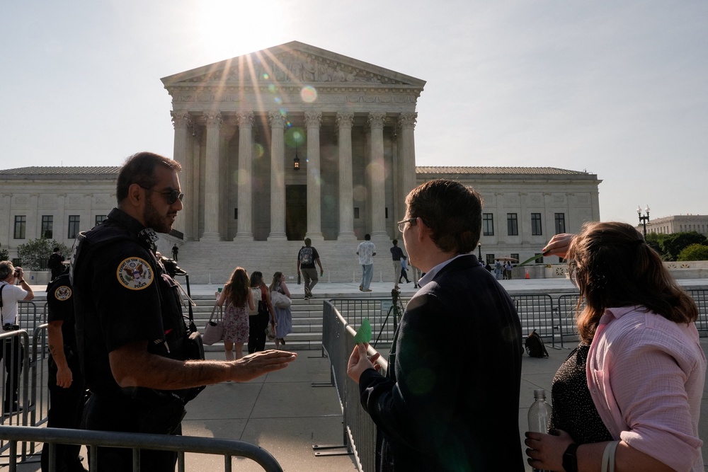 Police officers seen near barricades outside the Supreme Court building on Tuesday (Reuters)