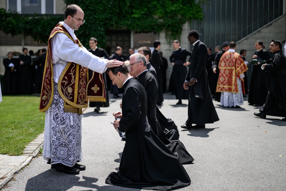Newly ordained priest Spain's Carlos Hernanz Gallego gives blessings to priests, after an ordination ceremony of the traditionalist Catholic Society of Saint Pius X (SSPX). (AFP/Getty)
