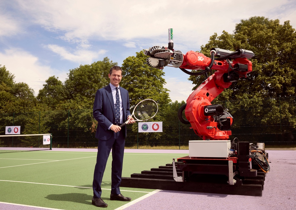 Tim Henman with Vodafone’s robotic serving arm (Vodafone/PA)