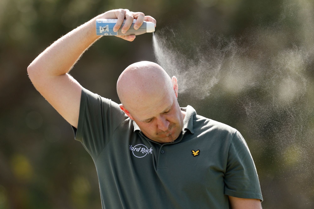 A golfer applies sunscreen at the Sony Open in Honolulu, Hawaii, earlier this year. Frequently applying sunscreen is critical to ensuring you don’t get burned (Getty Images)