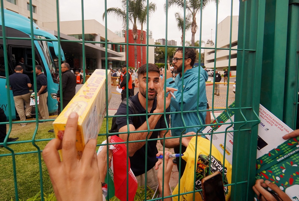 Iran's Milad Mohammadi signs autographs for fans (Reuters)