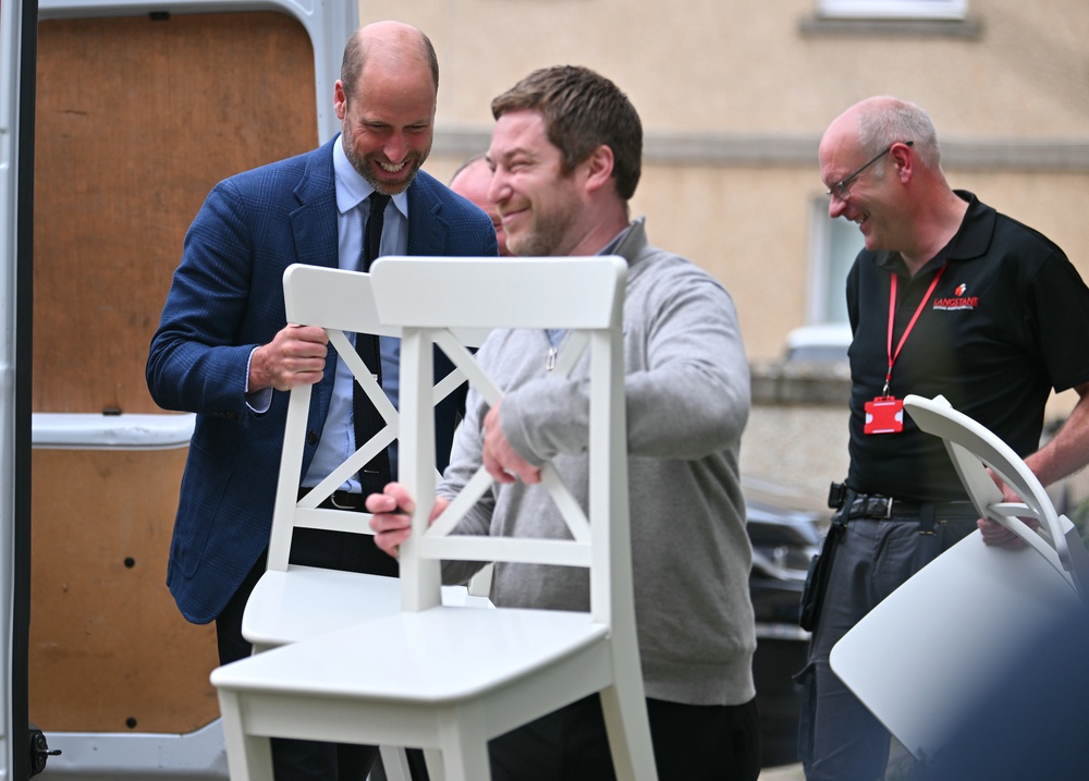 The Prince of Wales helps a new tenant (Andy Buchanan/PA) (PA Wire)