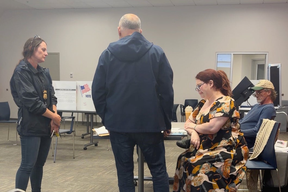 In this image from video provided by Sheilia Milledge, Paigelynne Gonyea, right, is presented with a form at a polling place on Tuesday, June 23, 2026, in Syracuse