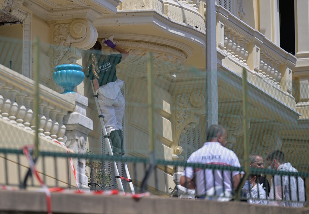 An investigator examines the scene at the residential building (AP)
