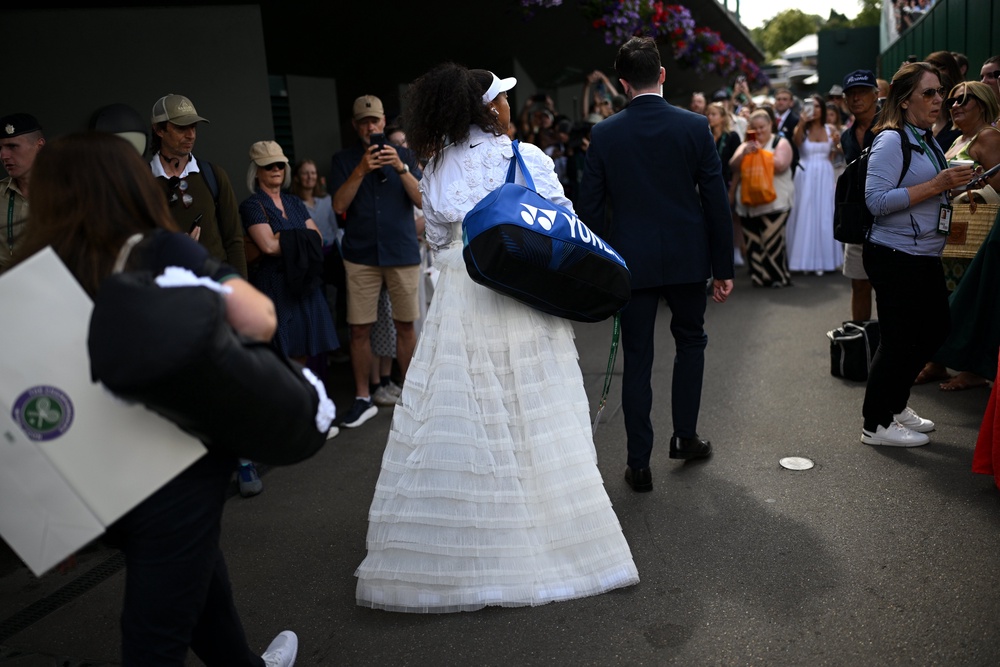 Osaka walked through the Wimbledon crowds to get to Court No 2 (Getty)