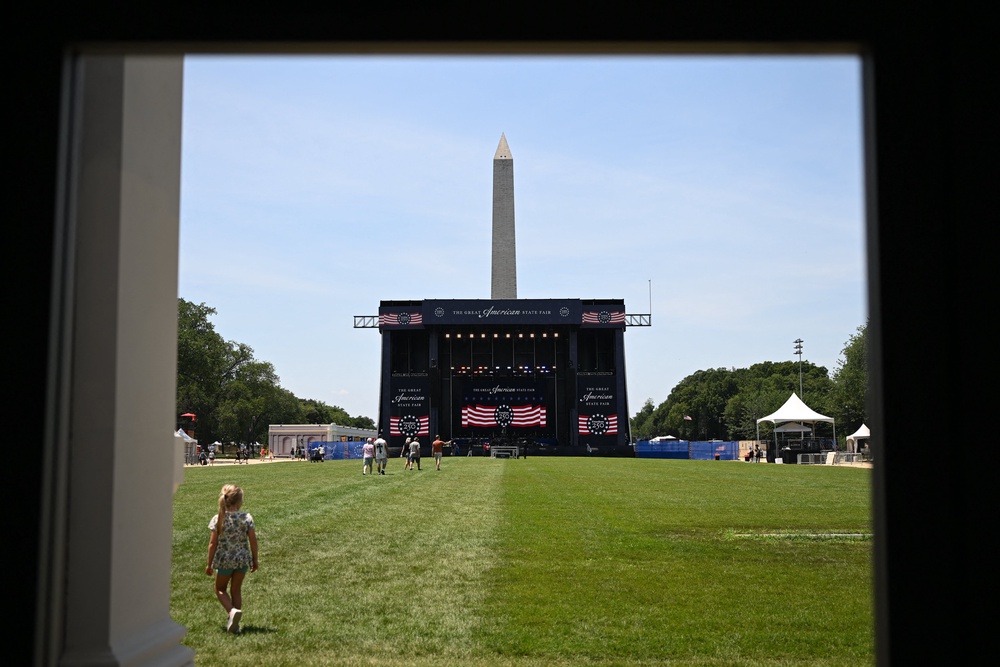 People were seen milling about on the open grass and standing awkwardly in front of sparsely populated gigs where musicians played other artists' hits — and outnumbered the audience. (AFP/Getty)