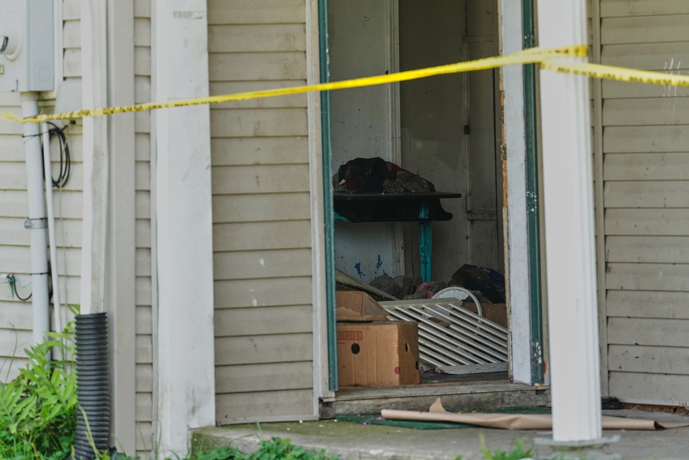 Items are seen beyond police tape in the home (AP)