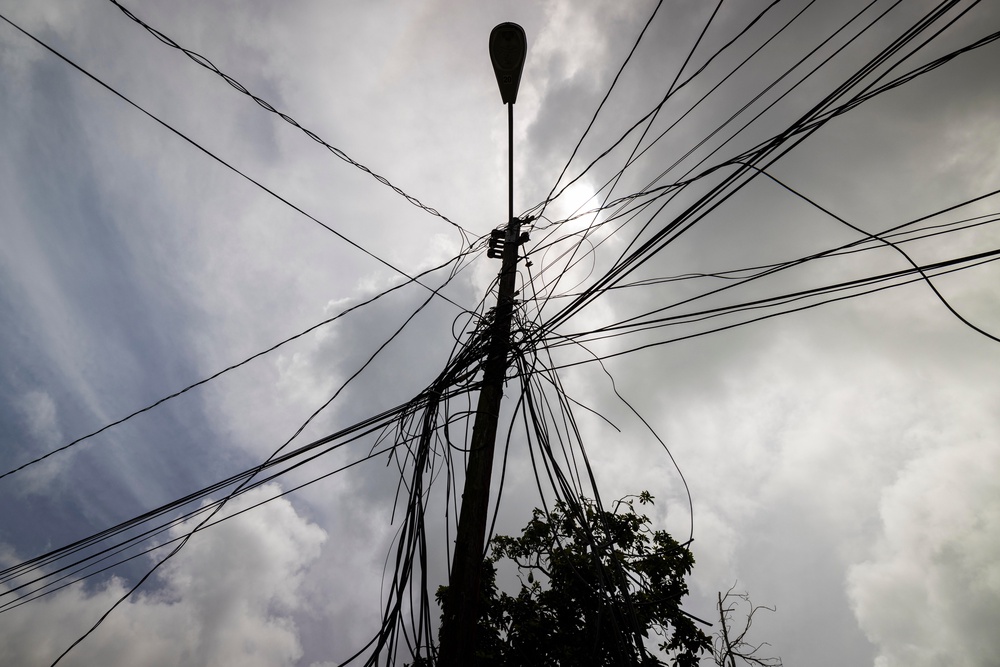 A utility pole with loose cables towers over the home of Jetsabel Osorio in Loiza, Puerto Rico (Copyright 2021 The Associated Press. All rights reserved)