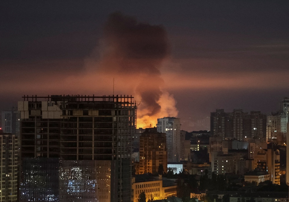 An explosion lights up the sky over Kyiv during a Russian missile and drone strike on 2 July 2026 (Reuters)