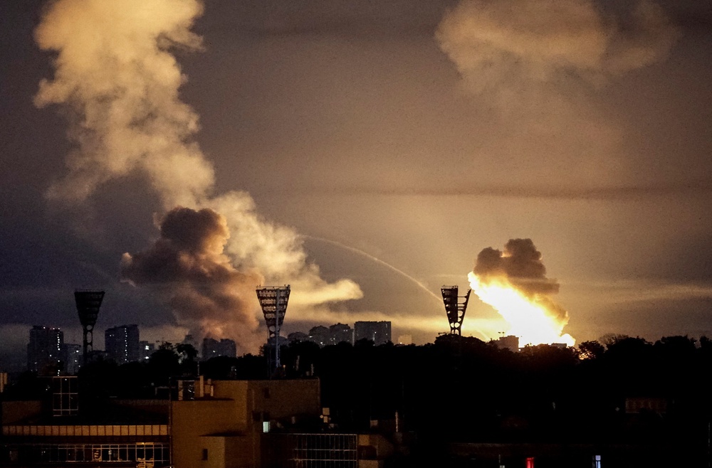An explosion lights up the sky over the city during a Russian missile and drone strike in Kyiv (Reuters)