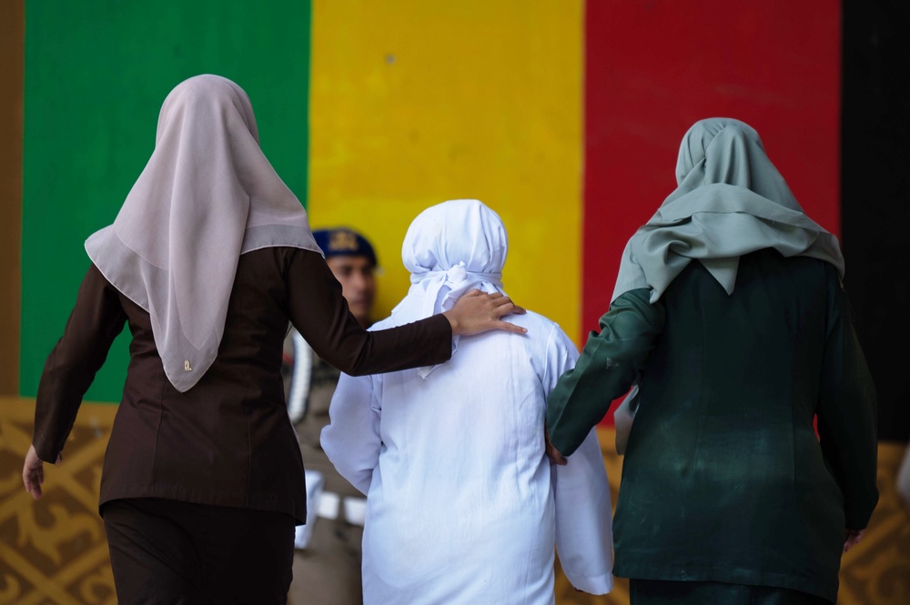 Shariah law officials escort a woman convicted of violating Islamic law by kissing a man, both unmarried, during a TikTok livestream after her public caning, in Banda Aceh, Indonesia, Thursday, July 2, 2026. (AP Photo/Reza Saifullah) (Copyright 2026 The Associated Press. All rights reserved.)