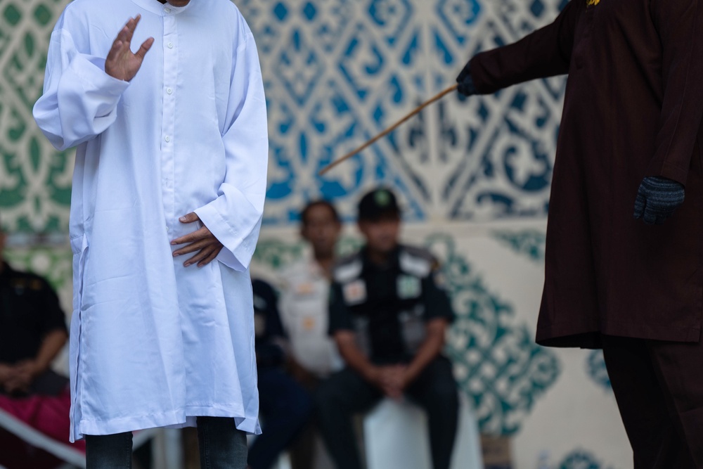 A man is publicly caned after he was convicted of violating Islamic law by kissing during a TikTok livestream, in Banda Aceh, Indonesia, Thursday, July 2, 2026. (AP Photo/Reza Saifullah) (Copyright 2026 The Associated Press. All rights reserved.)
