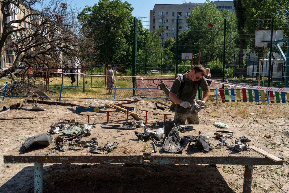 A Ukrainian serviceman inspects the remnants of a Russian missile in Darnytsia (Tom Watling)