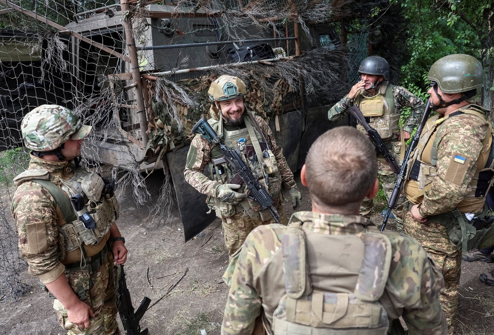 Servicemen of the 15th Kara-Dag Brigade chat before a combat mission (Reuters)
