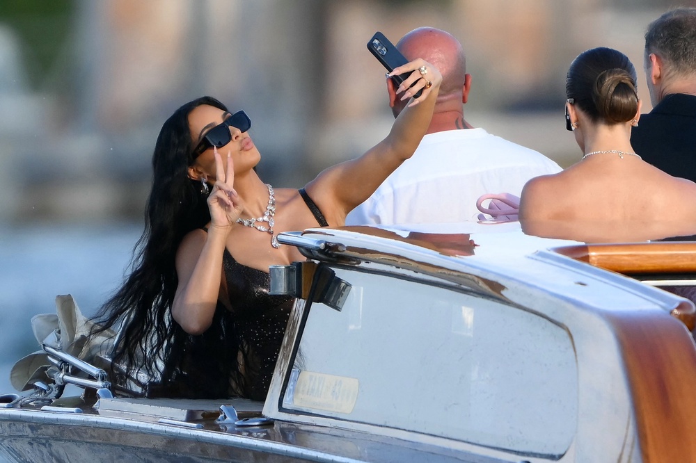 Following in her sister's footsteps? Kim Kardashian taking a selfie at Jeff Bezos' wedding (AFP/Getty)