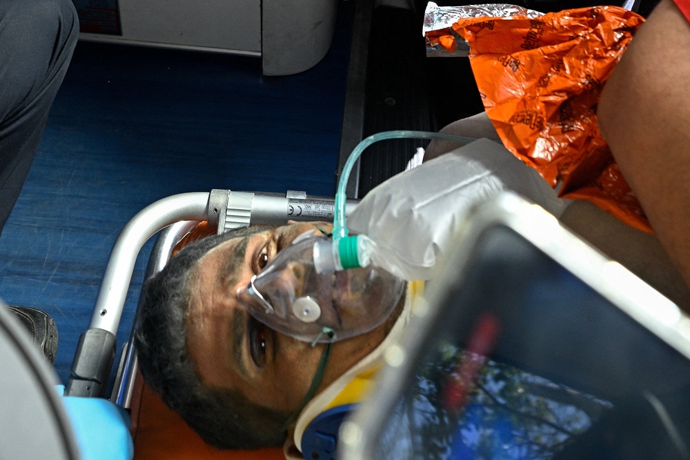 Hernan Gil, a survivor of Venezuela's twin earthquakes, is rushed into an ambulance by members of international rescue teams in Catia La Mar, La Guaira State, Venezuela on July 2, 2026 (AFP/Getty)