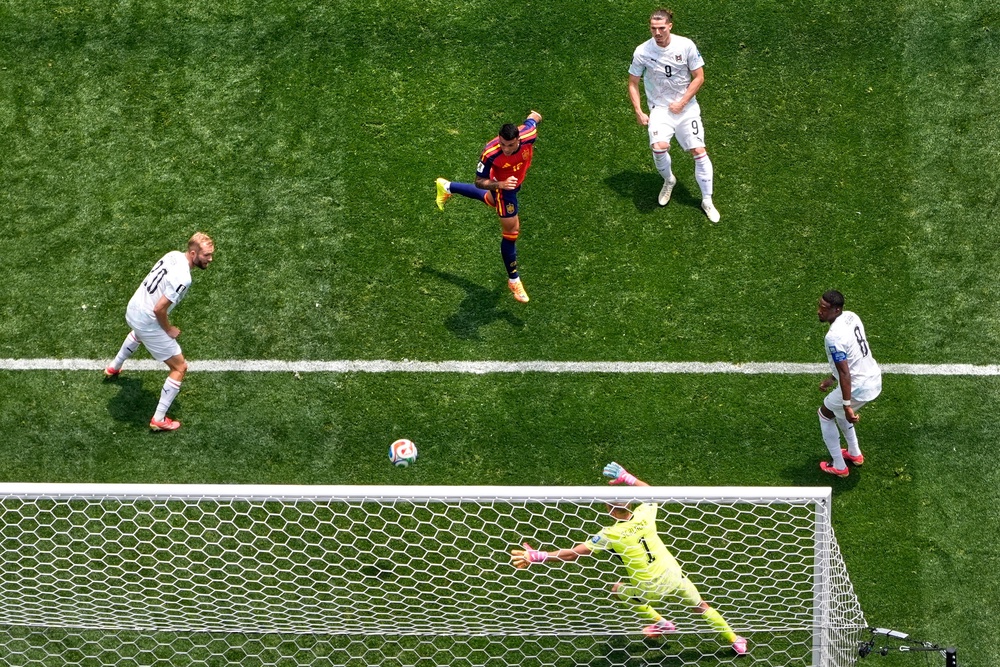 Pedro Porro heads home Spain's second in a 3-0 win over Austria (AP)